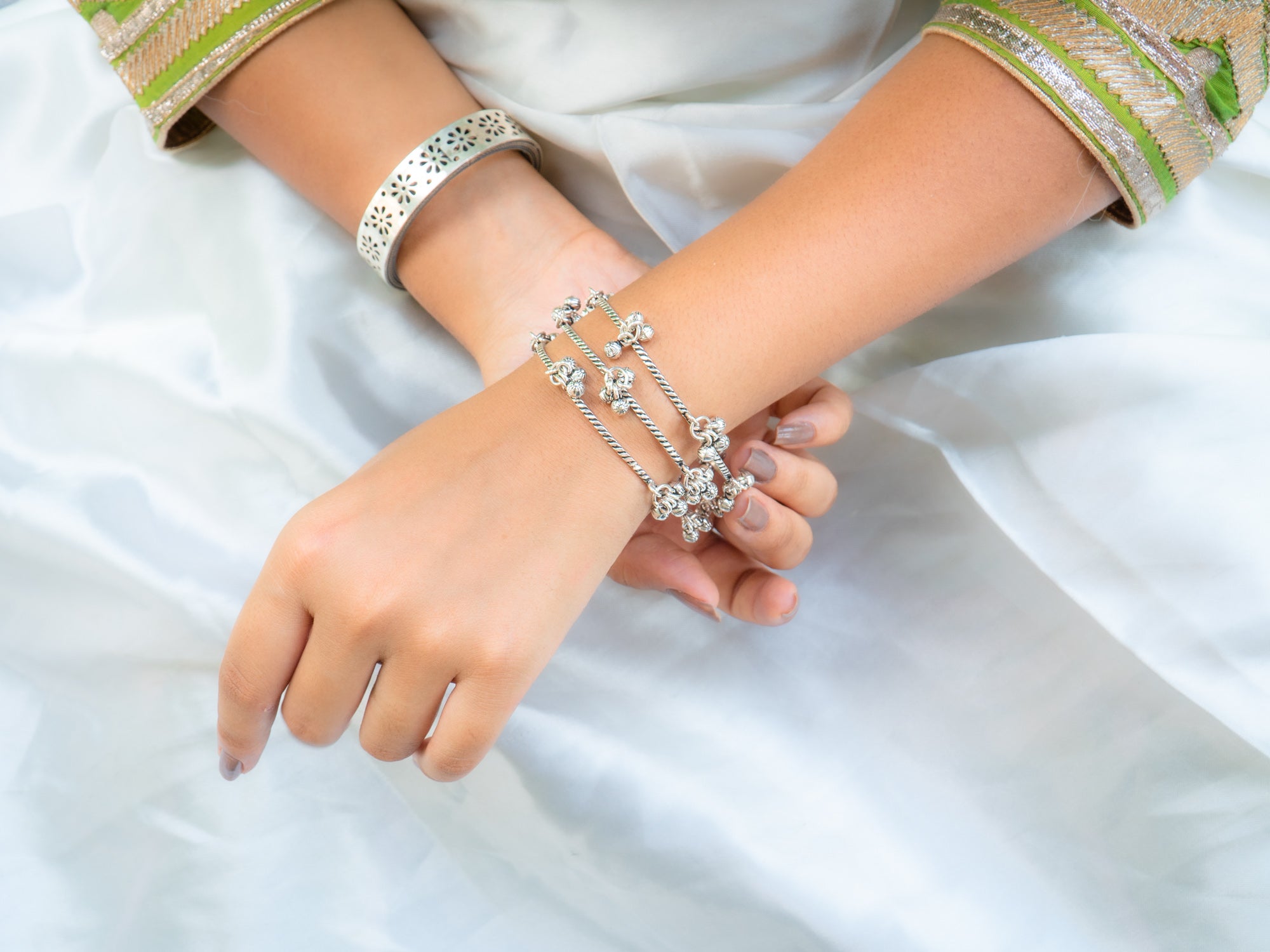 Stylish bracelets and clock on female hand top view Stock Photo by  ©belchonock 68299299
